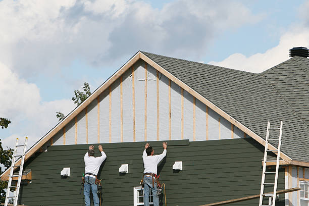 Professional Siding technician working in East Meadow, NY